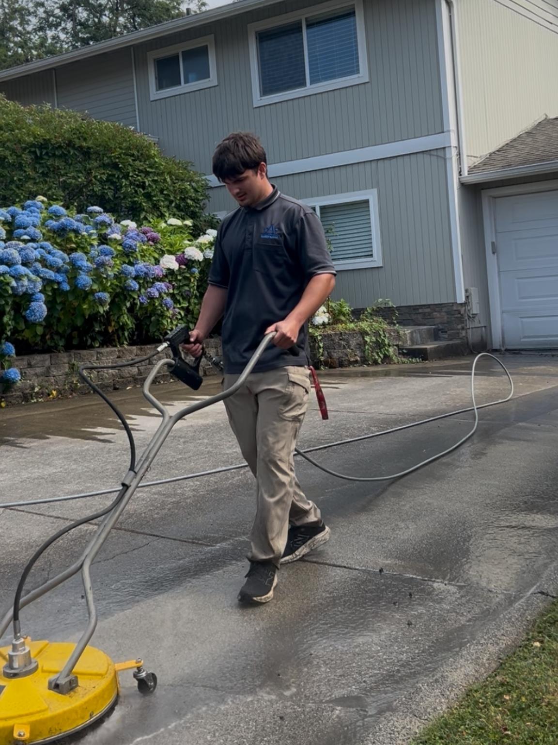 Professional concrete driveway cleaning in progress
