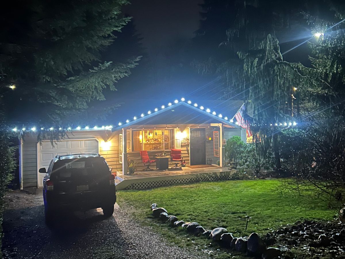 Warm white Christmas lights installed on a home roofline